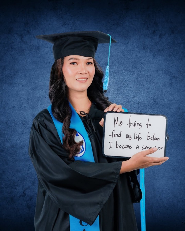 CleverCare graduate holding a handwritten sign about becoming a caregiver