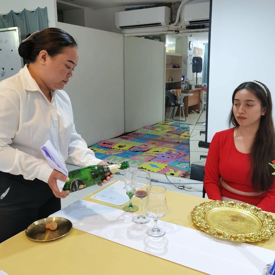 CleverCare student practicing formal table service as part of caregiving practicum