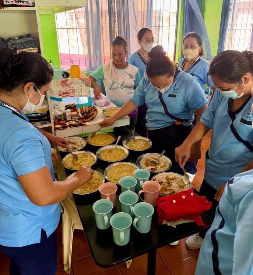 CleverCare students demonstrating proper feeding assistance during a community outreach event