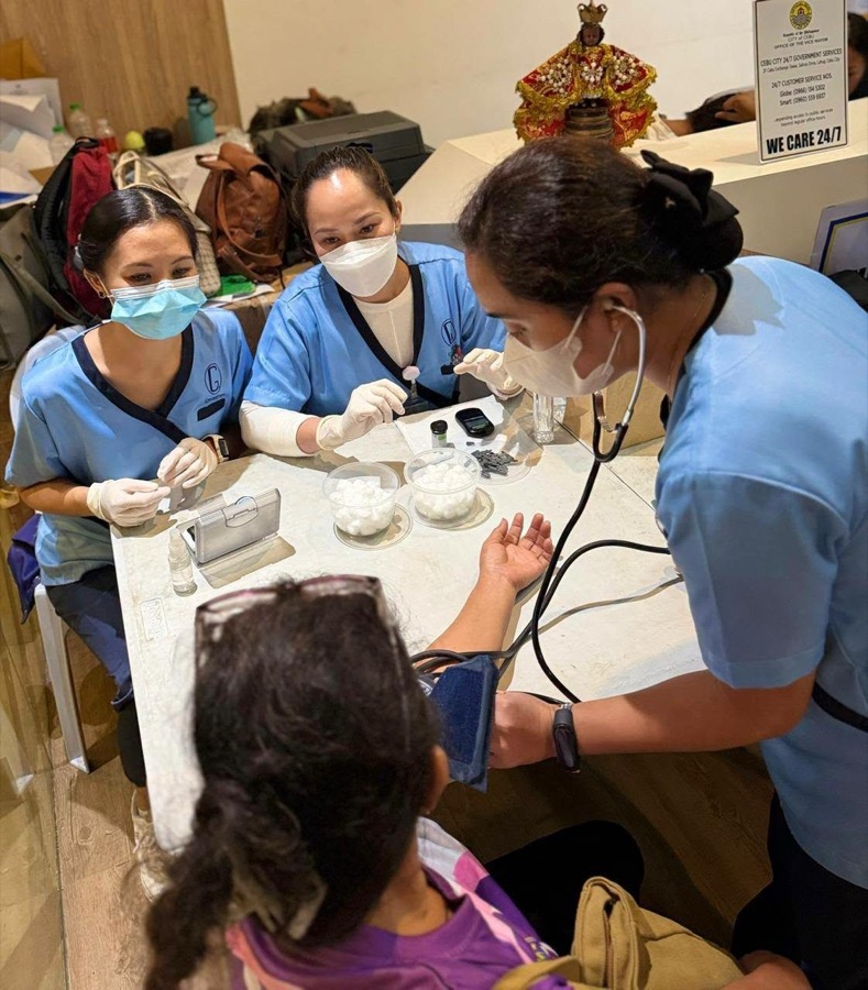 CleverCare students checking blood pressure and vitals during a City of Cebu outreach event